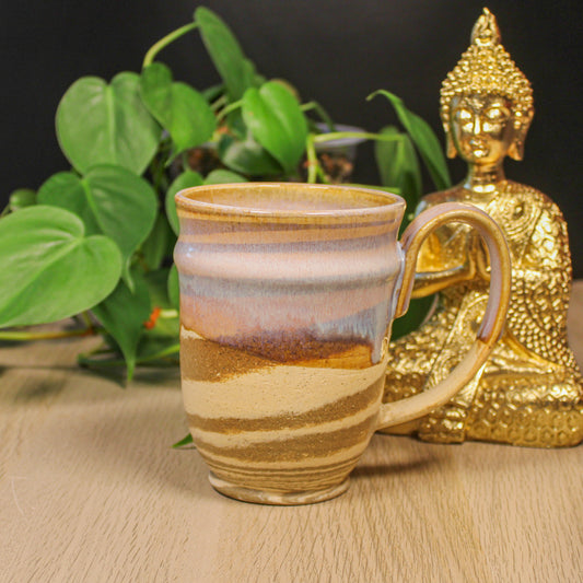 Handmade ceramic swirl mug by Emma Stewart, pottery mug with layered earth tone glaze and striped pattern