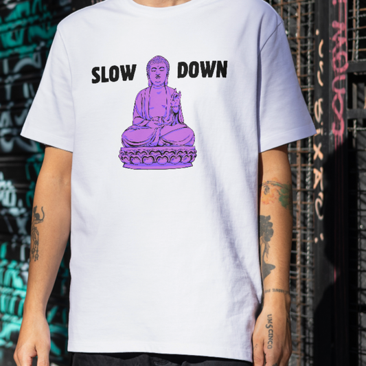 White t-shirt with purple meditating Buddha graphic and text Slow Down — Azenway mindfulness apparel.