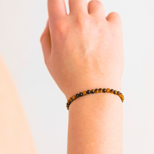 Tiger’s Eye crystal bracelet shown on wrist, highlighting the warm golden-brown gemstone beads.