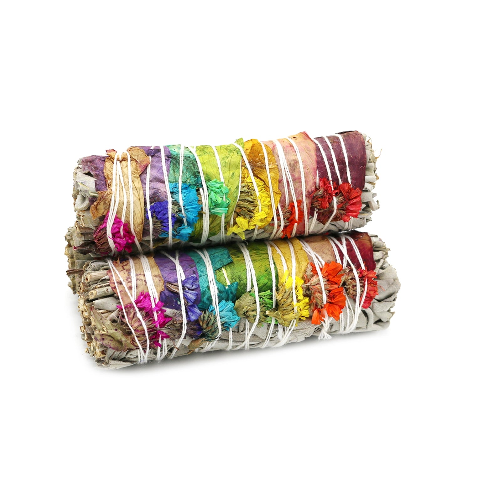 Two bundles of colorful sage smudge sticks on a white background