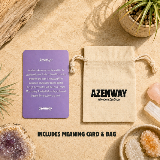 Amethyst crystal meaning card displayed beside an Azenway organic cotton drawstring gift bag with "Includes Meaning Card & Bag" text overlay. Set on a warm neutral background with natural crystals and botanical accents, showcasing the premium packaging included with every Amethyst purchase.