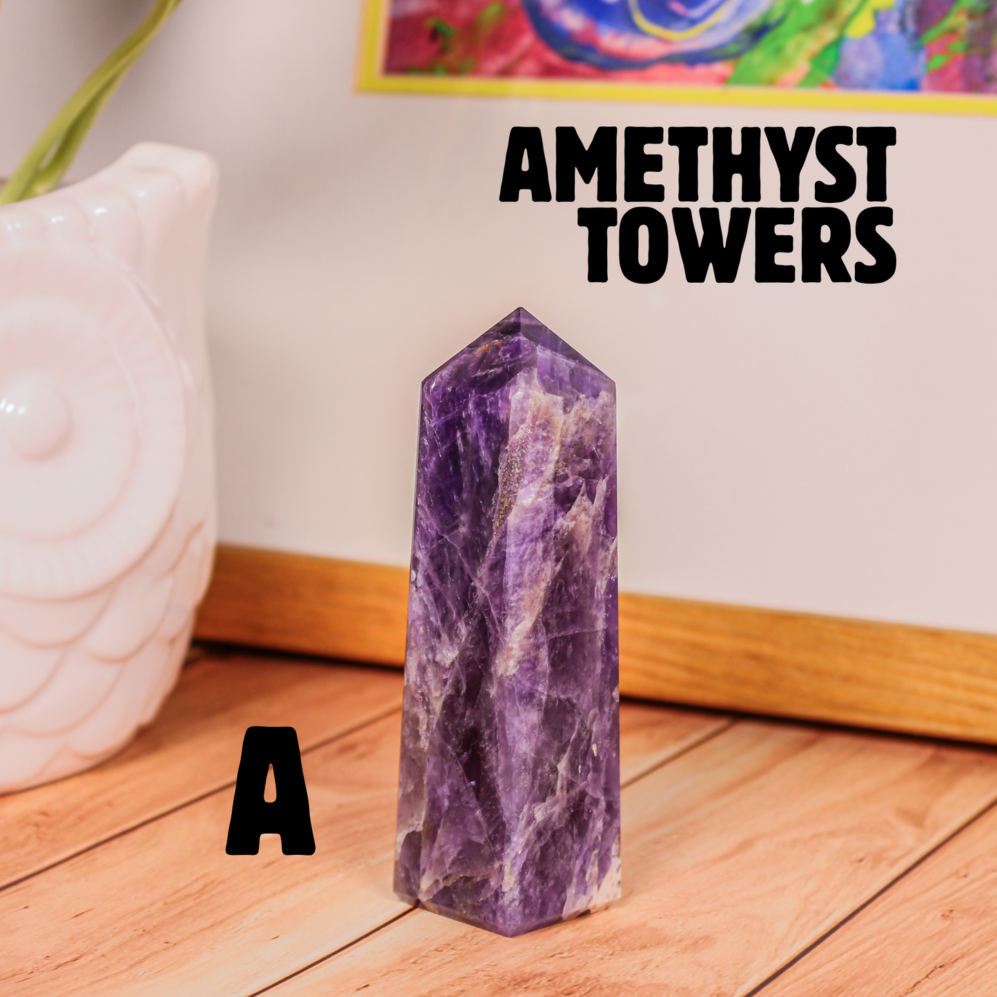 Amethyst crystal tower labeled A polished purple stone point photographed on wooden surface