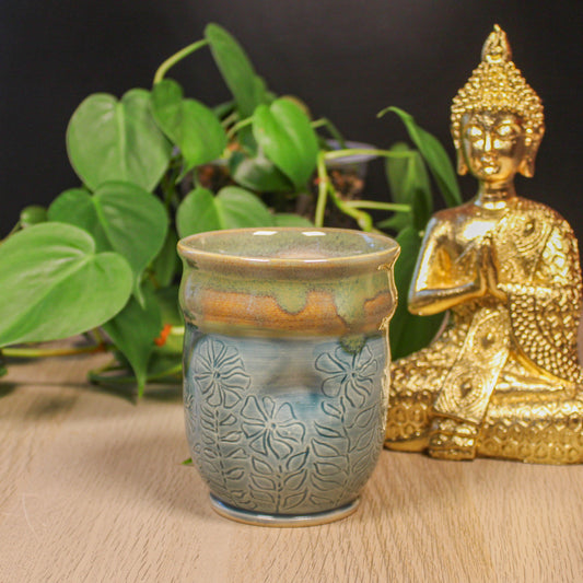 Handmade ceramic blue floral thumb cup by Emma Stewart, pottery cup with botanical pattern and multicolor glaze