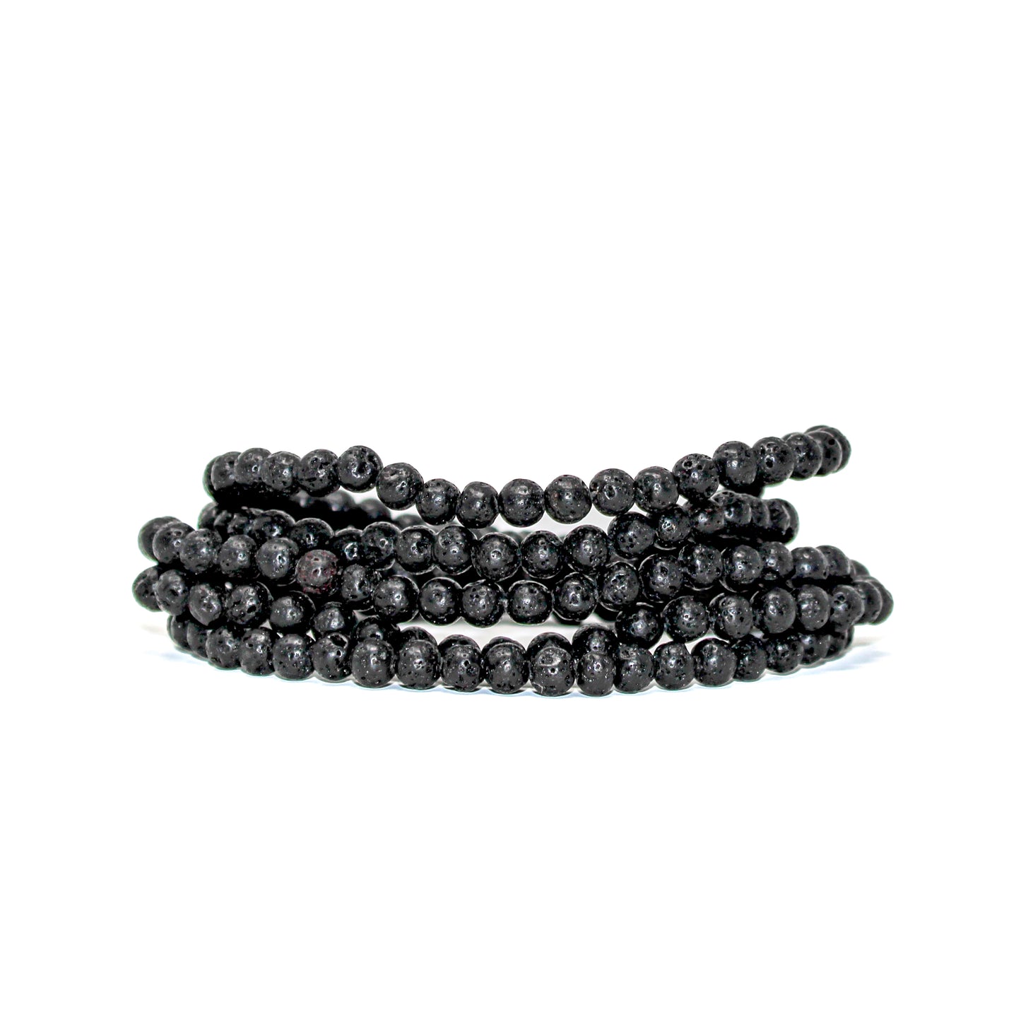 Close-up of stacked 4mm black lava stone beads showing their natural volcanic texture.
