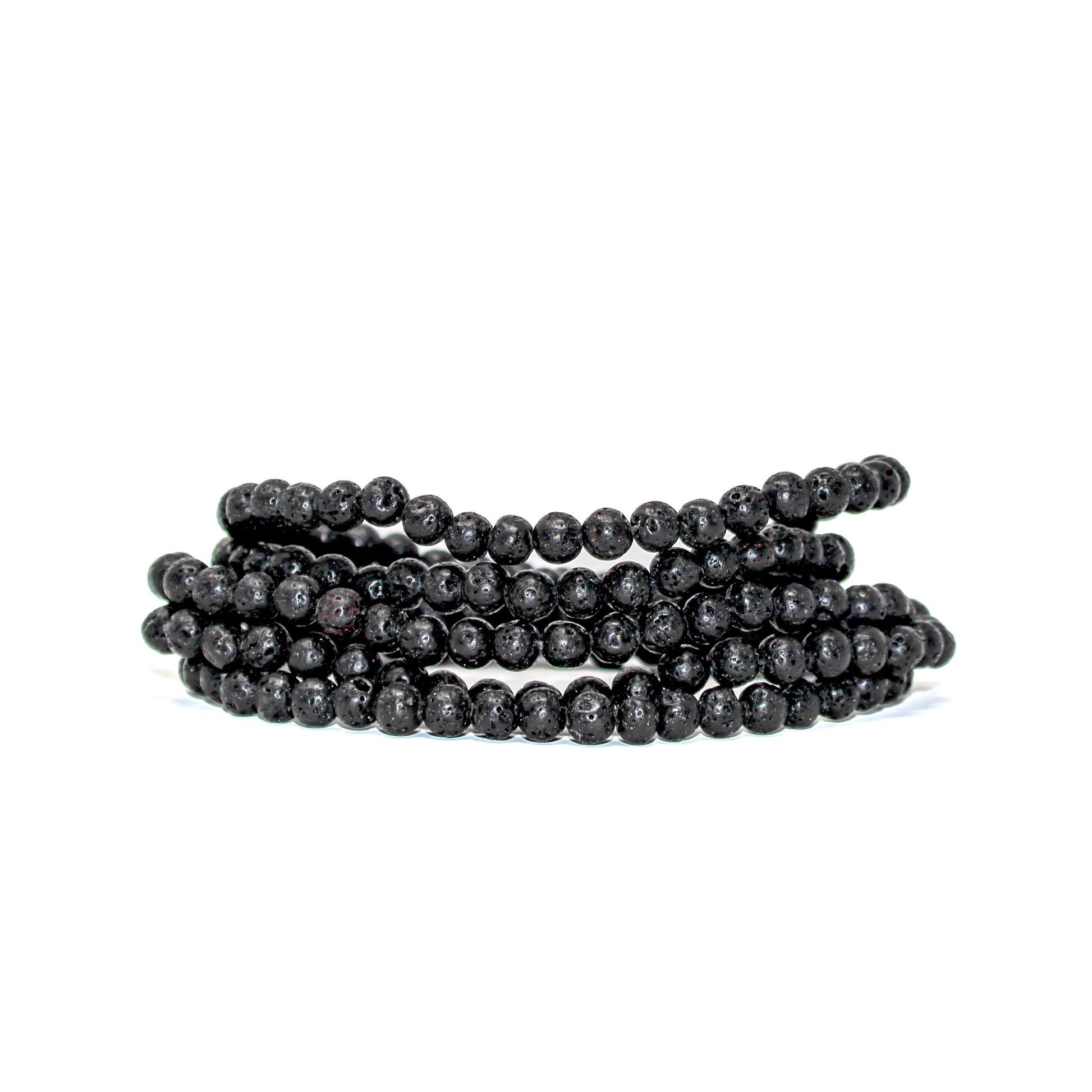 Close-up of stacked 4mm black lava stone beads showing their natural volcanic texture.
