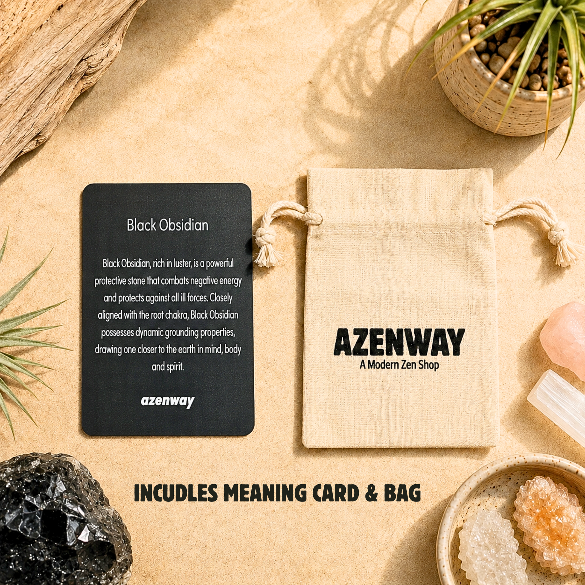 Black Obsidian crystal meaning card displayed beside an Azenway organic cotton drawstring gift bag with "Includes Meaning Card & Bag" text overlay. Set on a warm neutral background with Black Obsidian crystal accents and botanical décor, showcasing the premium packaging included with every Black Obsidian purchase.