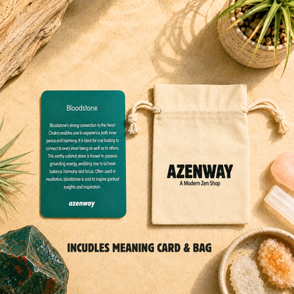 Bloodstone meaning card displayed beside an Azenway organic cotton drawstring bag on a warm zen-inspired backdrop, showing the included gift packaging for Bloodstone crystals.