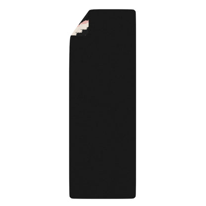 Black yoga mat with floral design on a white background