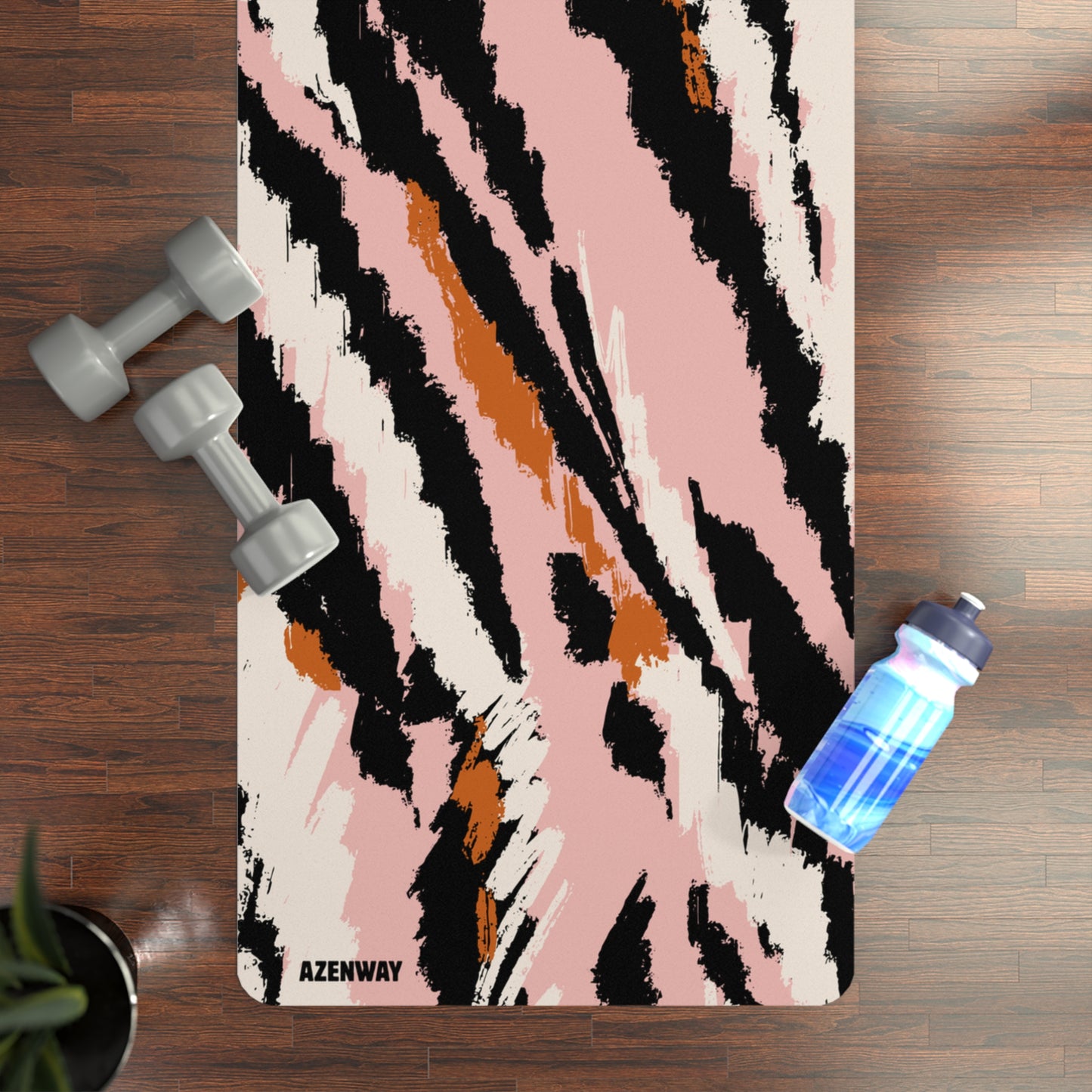 Yoga mat with abstract design on a wooden floor with dumbbells and a water bottle.