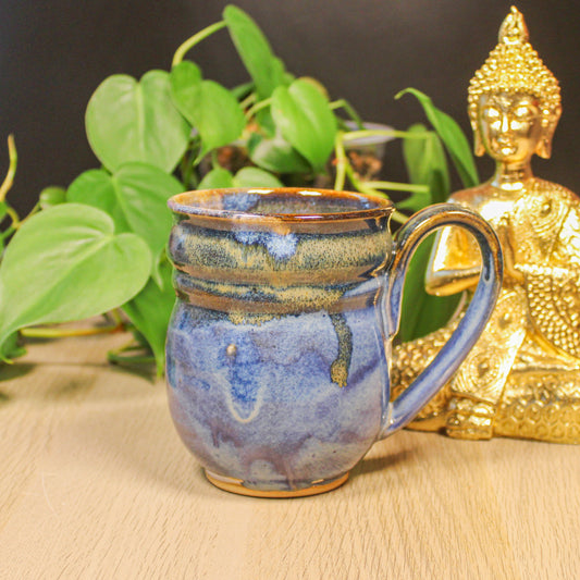 Handmade ceramic blue mug by Emma Stewart, pottery mug with layered blue and earthy glaze and curved handle