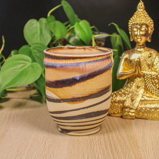 Handmade ceramic swirl cup by Emma Stewart, pottery cup with layered earth tone stripes and flowing glaze