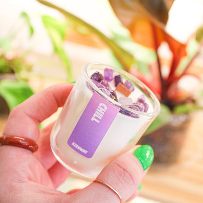 Hand holding mini amethyst crystal candle with wooden wick and essential oil blend by Azenway