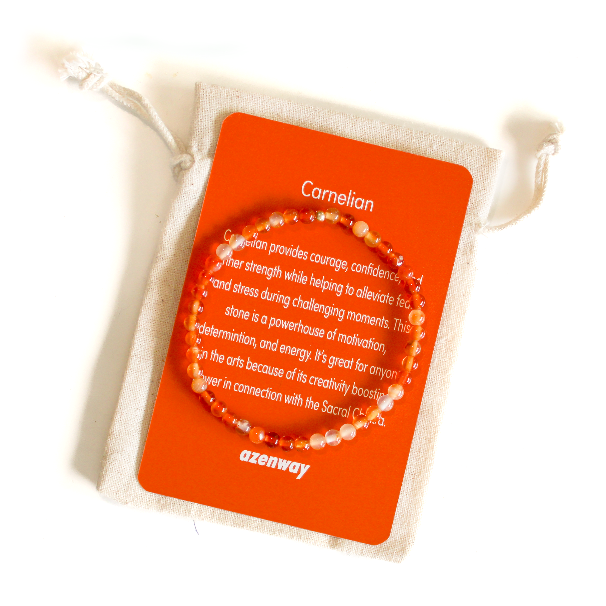 A Carnelian crystal bracelet with a gold accent bead, displayed on a card with information about the product.