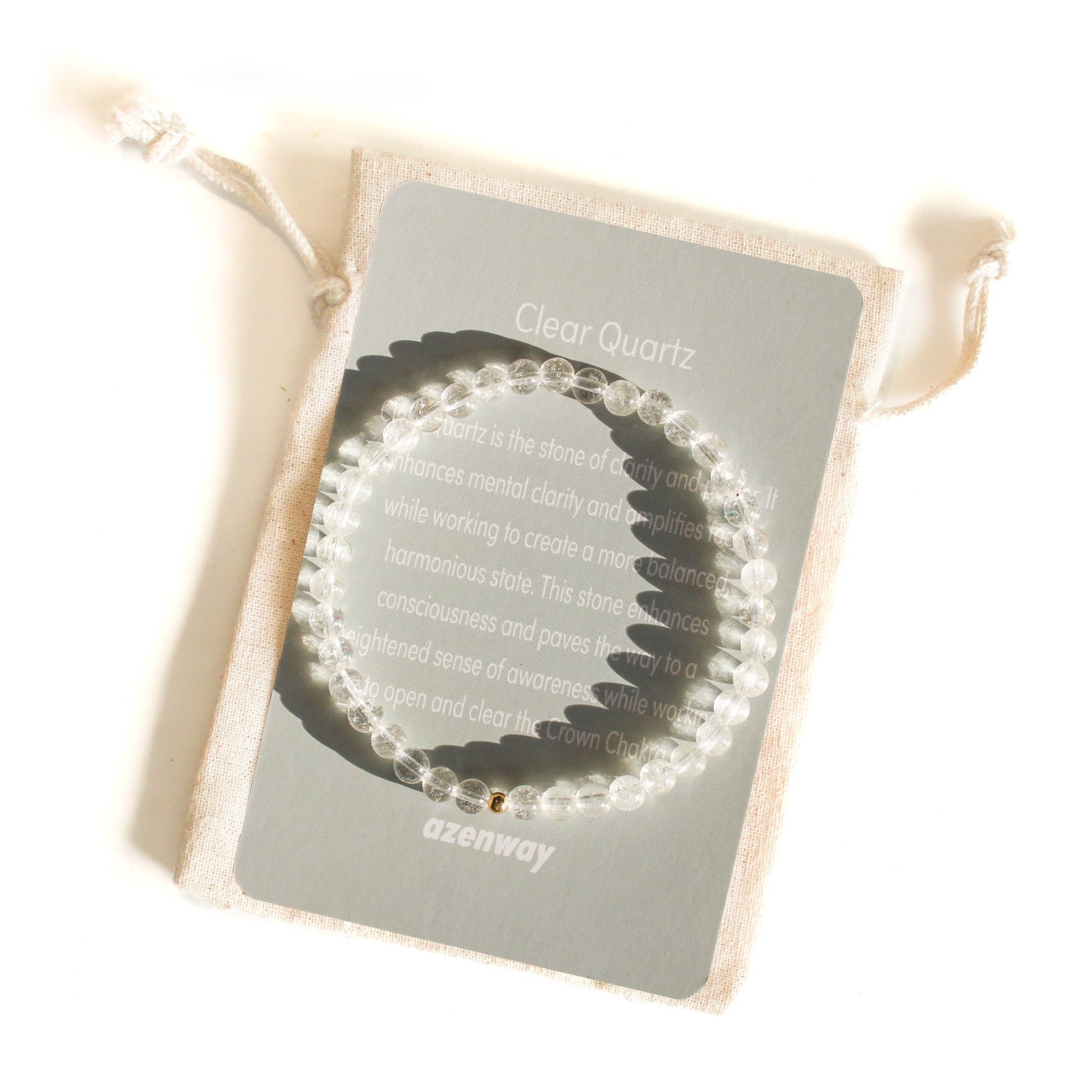 Clear Quartz 4mm gemstone bracelet with 14k gold-filled accent displayed on Azenway meaning card and linen gift bag.