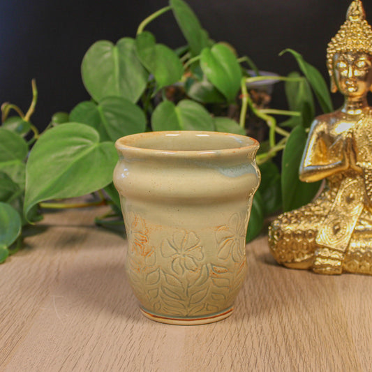 Handmade ceramic floral cup by Emma Stewart, thumb indent pottery cup with soft green glaze and botanical design