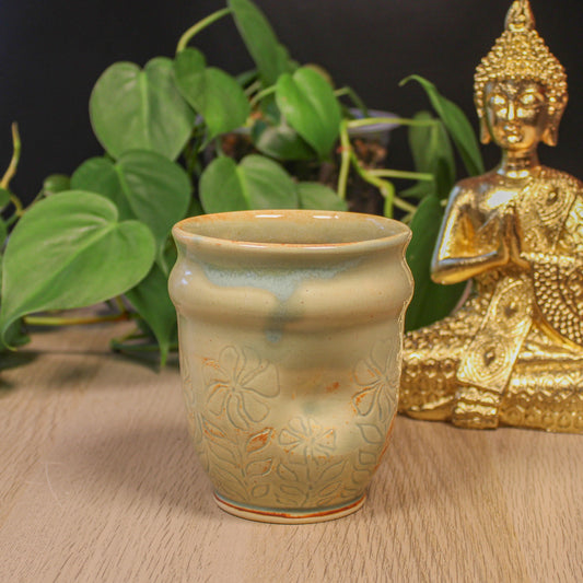 Handmade ceramic floral cup by Emma Stewart, thumb indent pottery cup with soft green glaze and botanical design