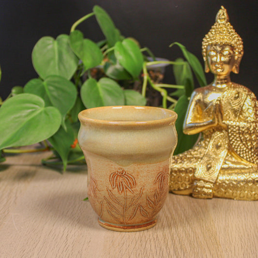 Handmade ceramic floral thumb cup by Emma Stewart, earthy pottery cup with embossed flower design and warm tan glaze