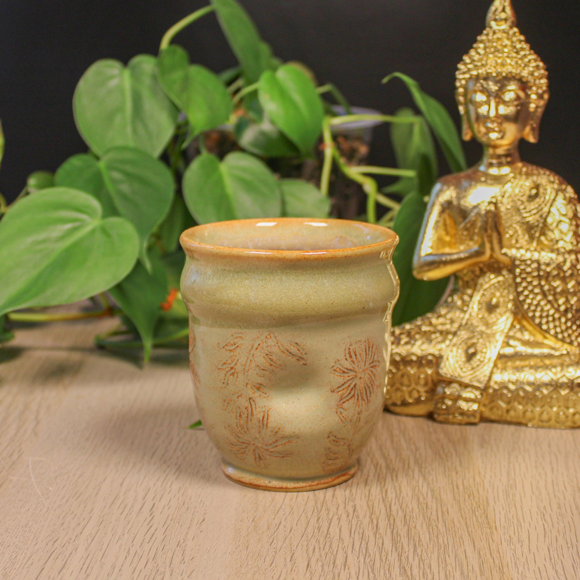 Handmade ceramic floral thumb cup by Emma Stewart, pottery cup with thumb indent and soft earthy glaze