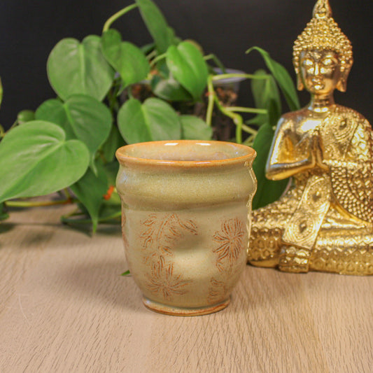 Handmade ceramic floral thumb cup by Emma Stewart, pottery cup with thumb indent and soft earthy glaze
