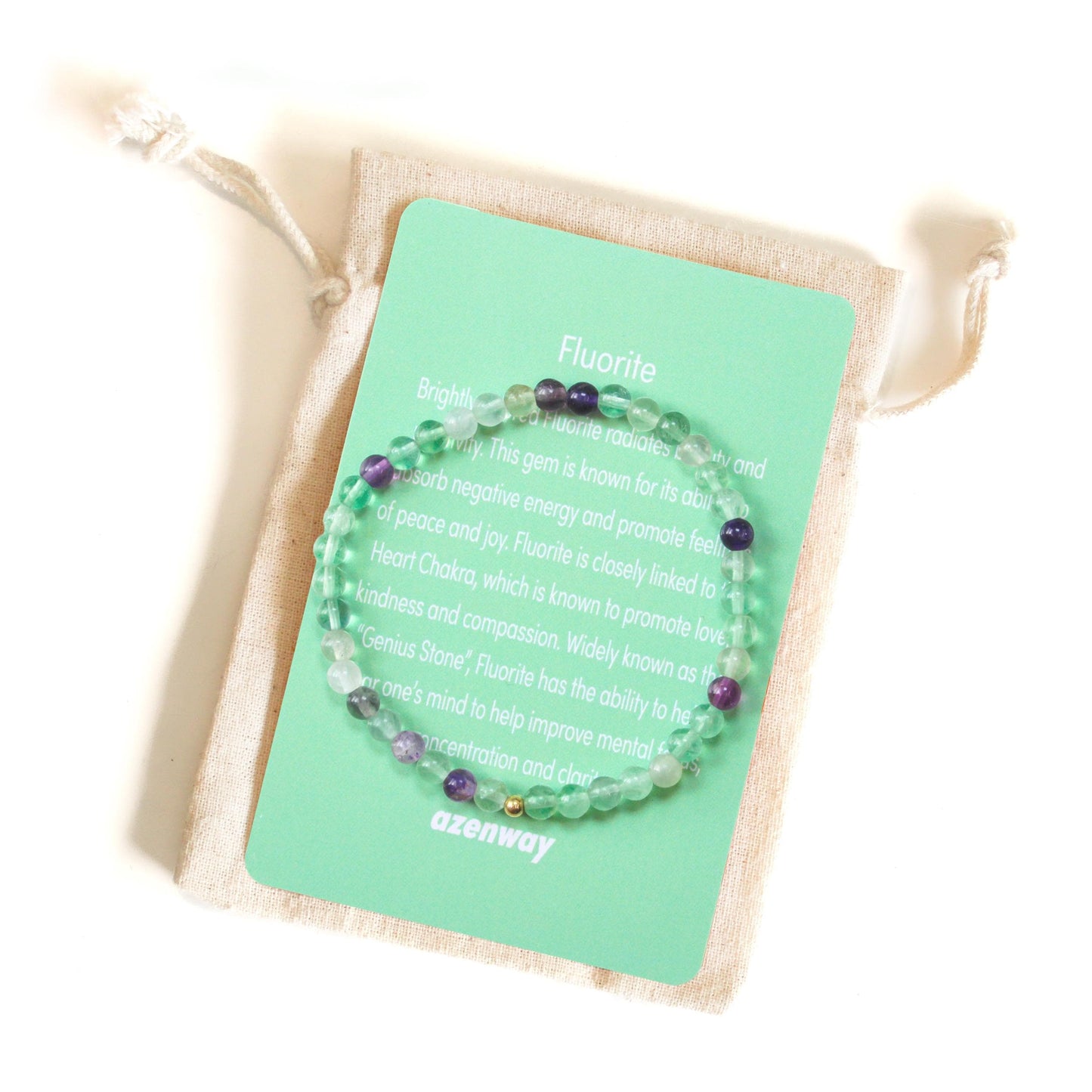 Fluorite 4mm gemstone bracelet with gold-filled accent displayed on green Azenway information card.