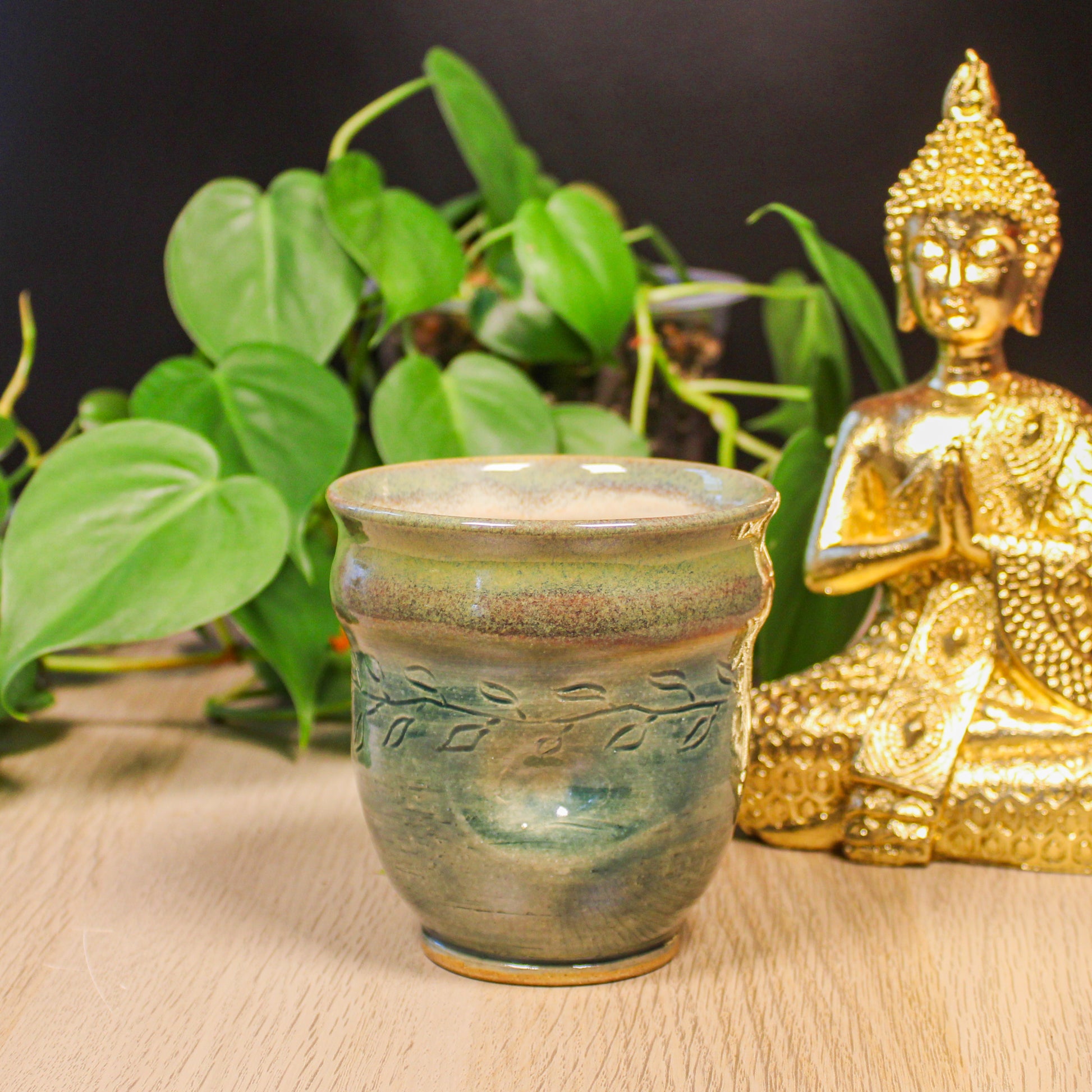 Handmade ceramic green thumb cup by Emma Stewart, pottery cup with leaf pattern and earthy glaze