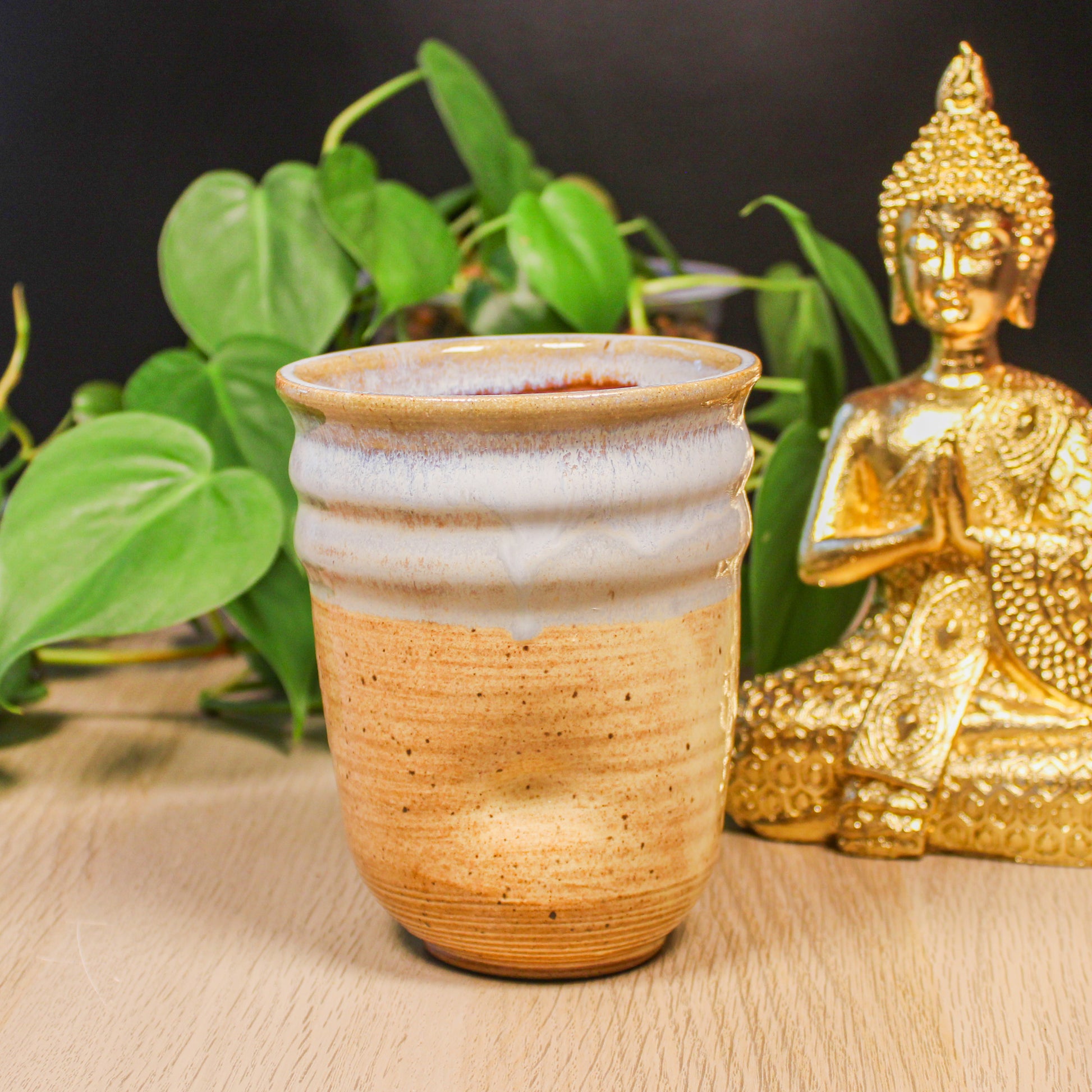 Handmade ceramic thumb cup by Emma Stewart, pottery cup with soft white glaze and natural clay base