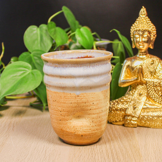 Handmade ceramic thumb cup by Emma Stewart, pottery cup with soft white glaze and natural clay base