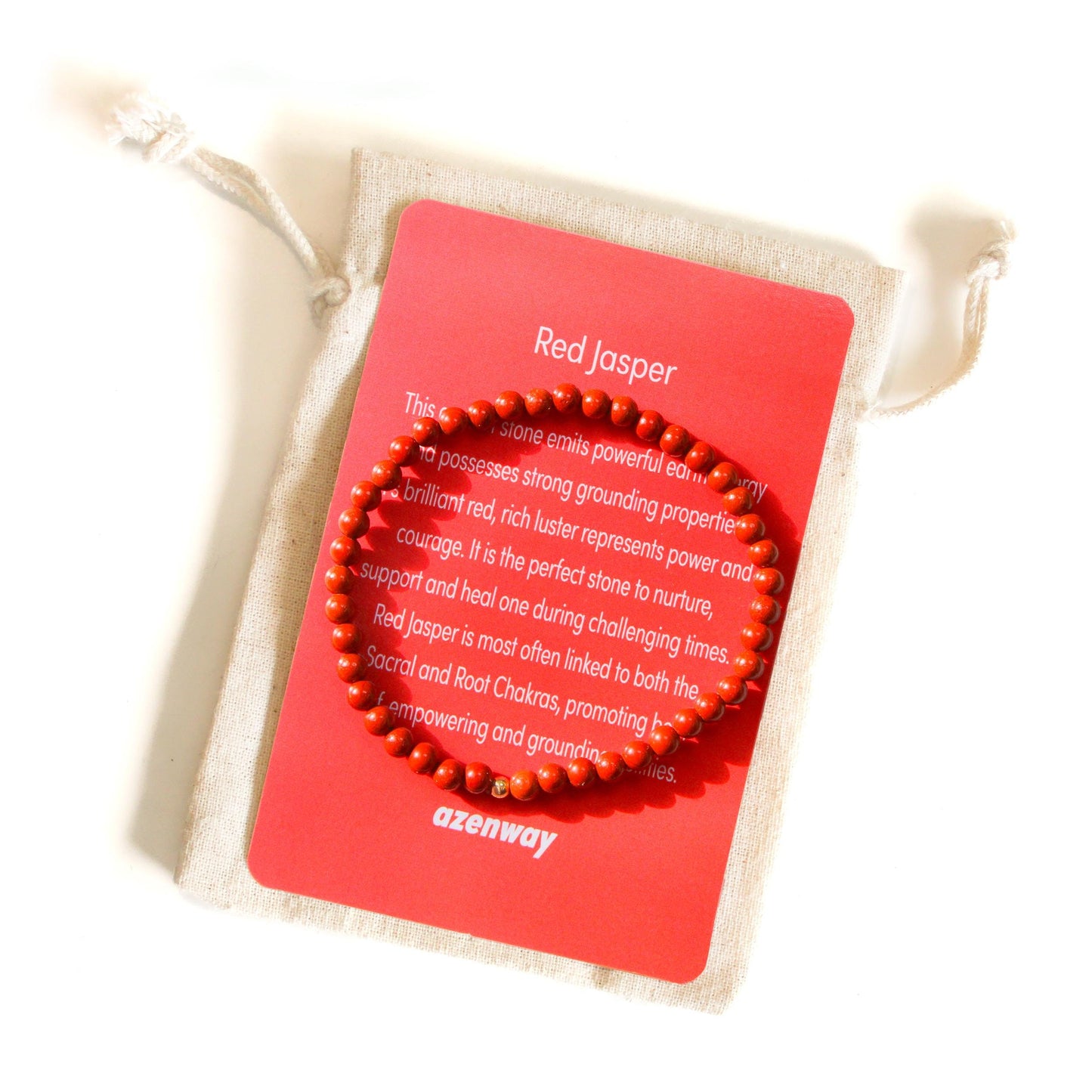 Red Jasper Bracelet displayed on red Azenway meaning card with cotton gift bag — natural 4mm stones and gold-filled accent