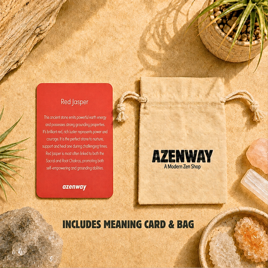 Red Jasper meaning card and Azenway drawstring bag displayed on a warm, zen-inspired background with crystals and greenery. Text reads “Includes Meaning Card & Bag.”