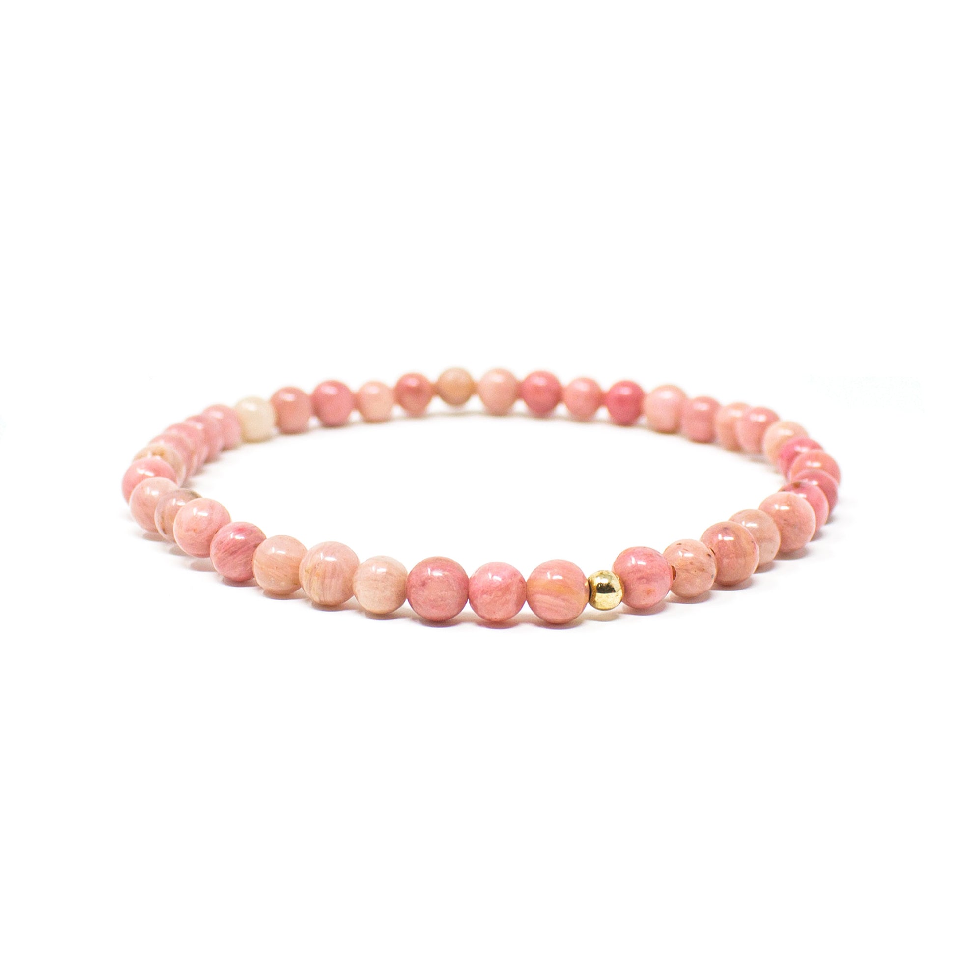 Close-up view of a 4mm Rhodonite gemstone bracelet with a single gold-filled accent bead, showing the natural pink tones of the stones.
