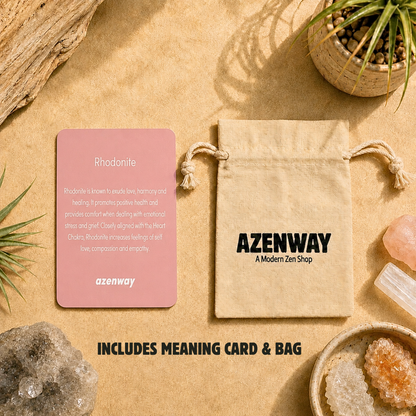 Rhodonite meaning card and Azenway drawstring bag displayed on a warm, zen-inspired background with crystals and greenery. Text reads “Includes Meaning Card & Bag.”