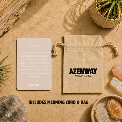 Azenway Selenite meaning card and branded drawstring bag displayed on a warm beige zen-inspired background with crystals, greenery, and text reading “Includes Meaning Card & Bag.”