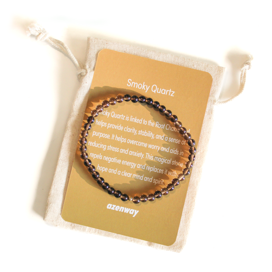 Smoky Quartz 4mm crystal bracelet with gold-filled accent displayed on its tan Azenway meaning card.