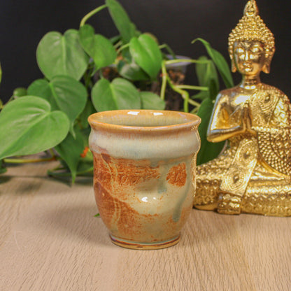 Handmade ceramic thumb cup by Emma Stewart, rustic pottery cup with earthy glaze and organic texture
