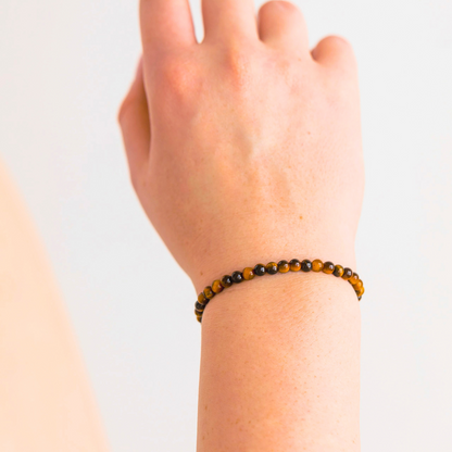 Tiger’s Eye crystal bracelet shown on wrist, highlighting the warm golden-brown gemstone beads.