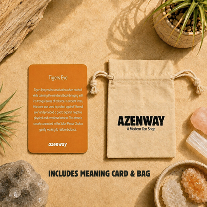 Tiger’s eye meaning card and Azenway drawstring bag displayed on a warm, zen-inspired background with plants and crystals. Text reads “Includes Meaning Card & Bag.”