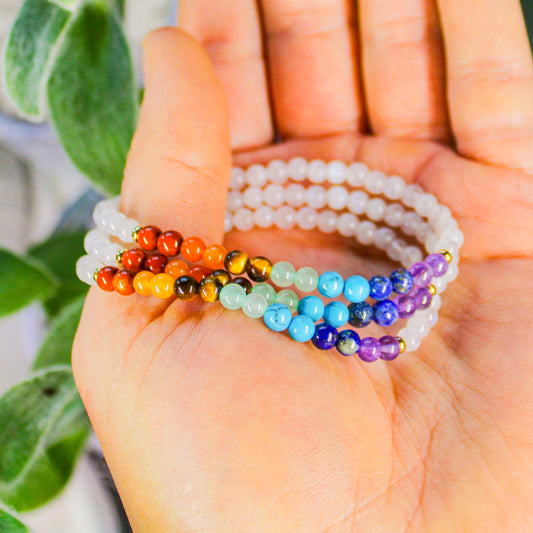 7 Chakra Moonstone bracelet shown on hand with Red Jasper, Orange Aventurine, Tiger’s Eye, Green Aventurine, Turquoise, Lapis Lazuli and Amethyst stones