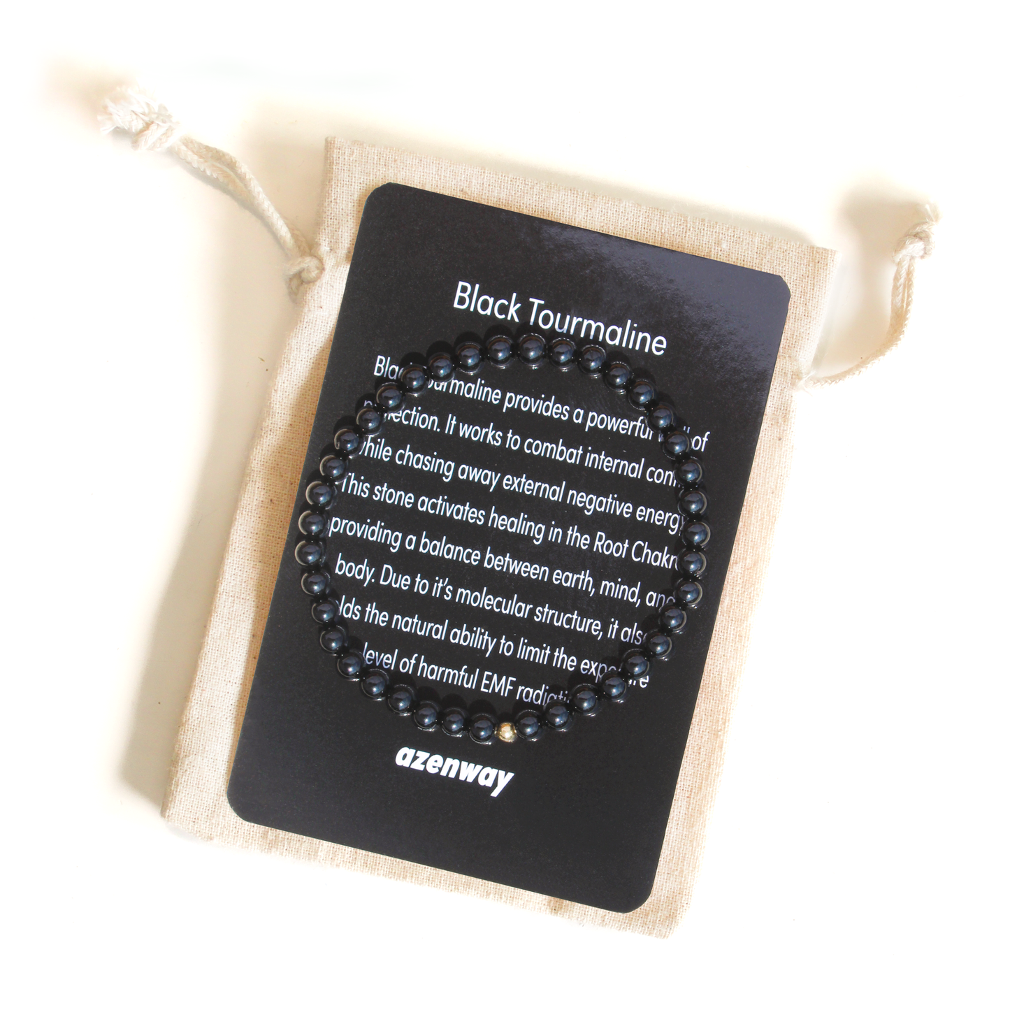 Black Tourmaline gemstone bracelet displayed on Azenway meaning card with organic cotton gift bag.